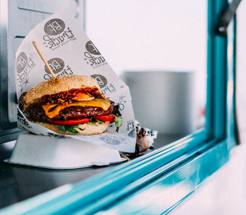 Picture of a hamburger sitting in a window.