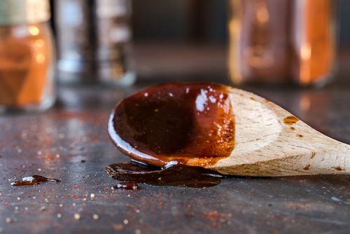 Barbecue sauce on a mixing spoon.