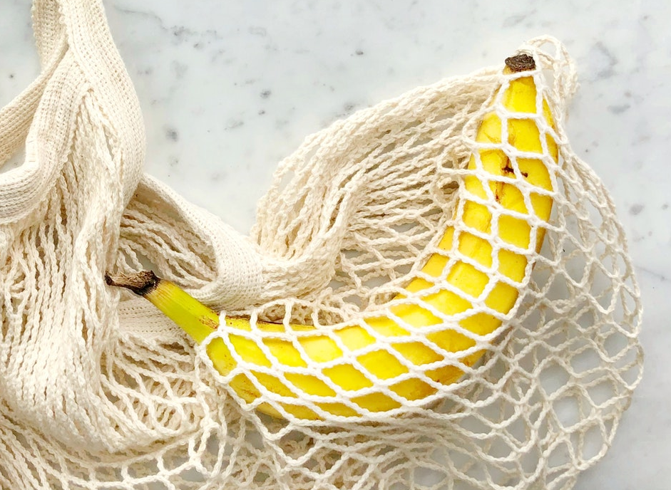 Picture of a banana in a cloth net.