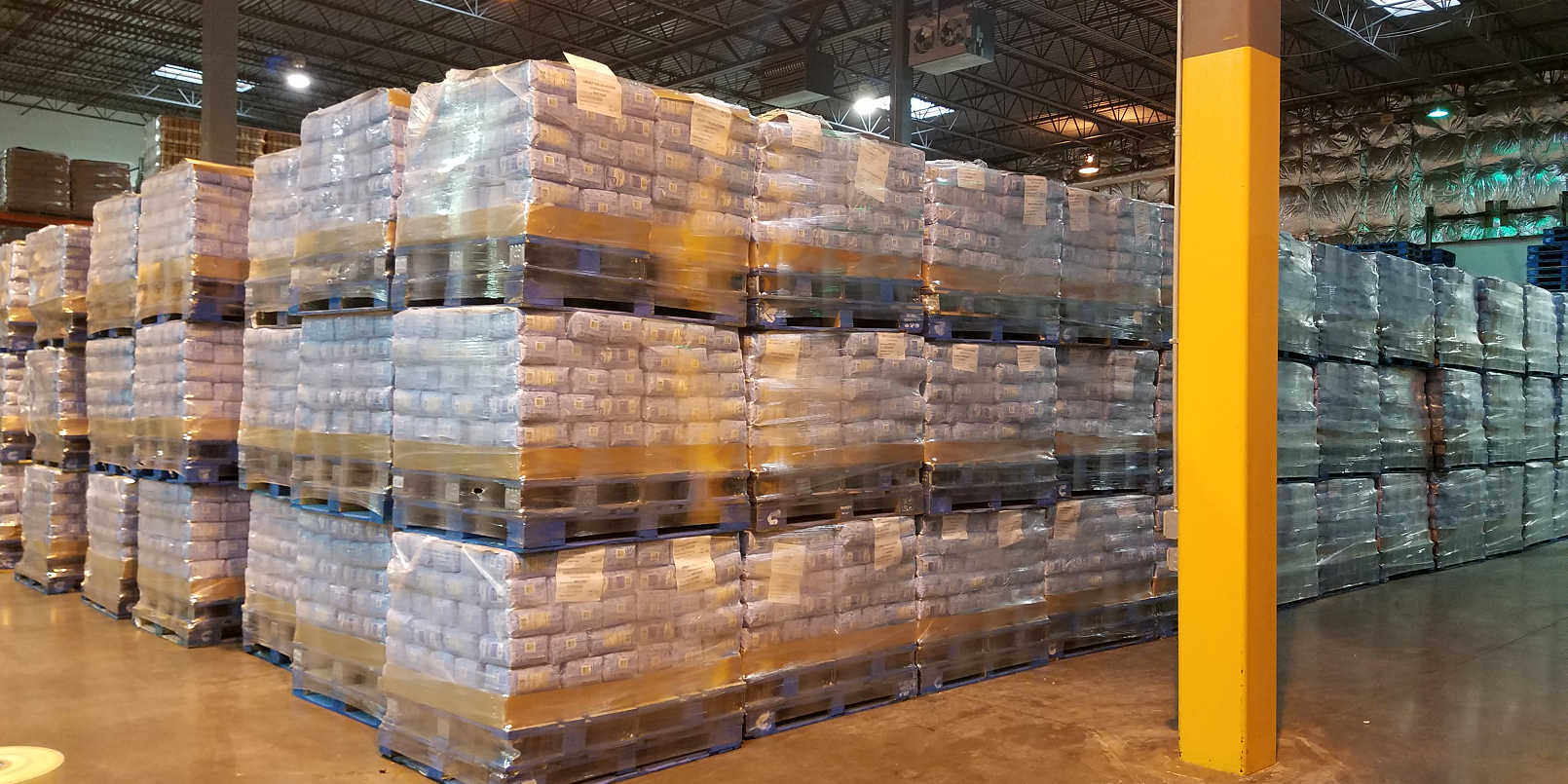 Picture of stacked and stored pallets of sugar.