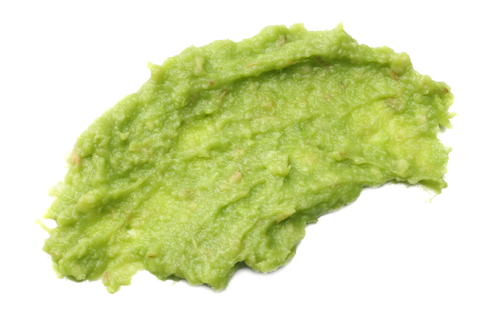 Picture of guacamole spread on a white background.